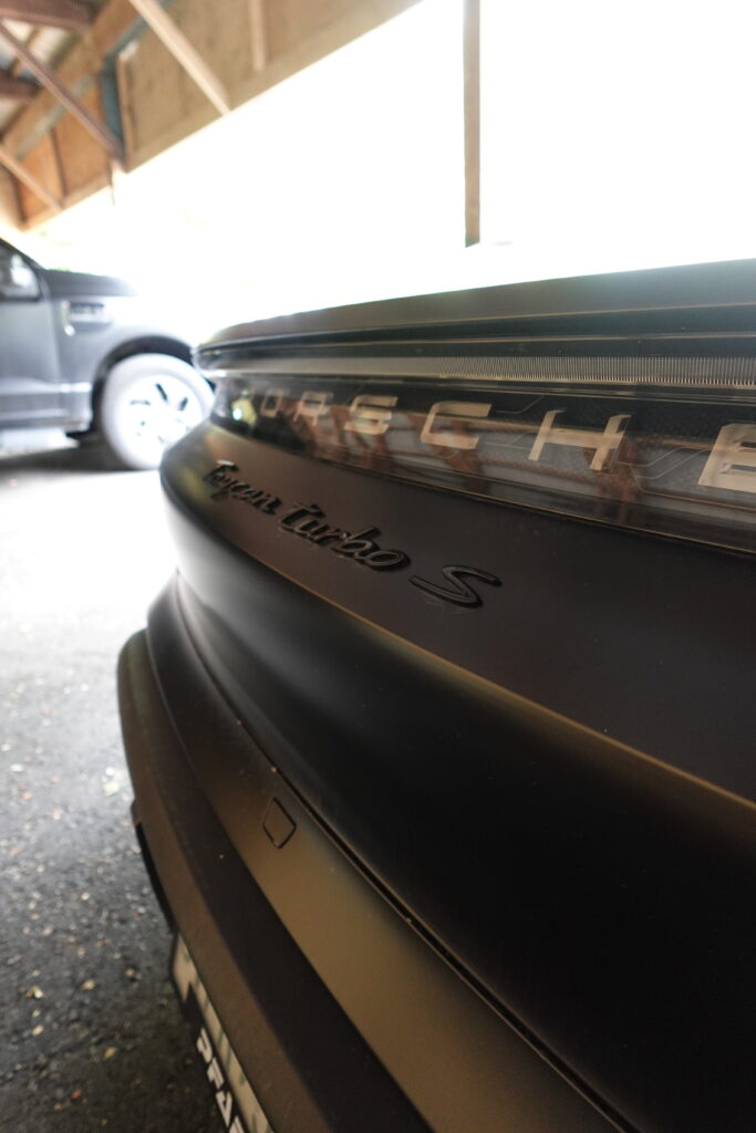 Close up of the rear of a black Porsche Taycan Turbo S after detailed in Croydon