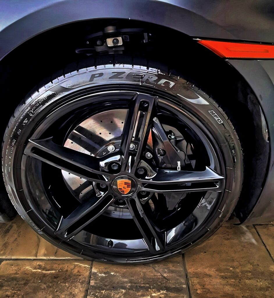 Clean Porsche wheel with a spotless finish after being detailed