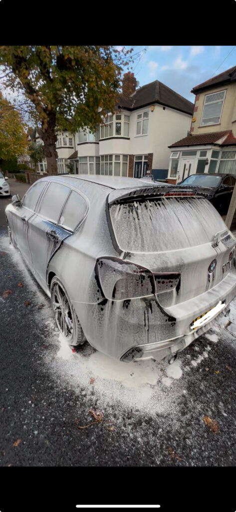 bmw m140i covered in thick snow foam during an exterior detail in Croydon