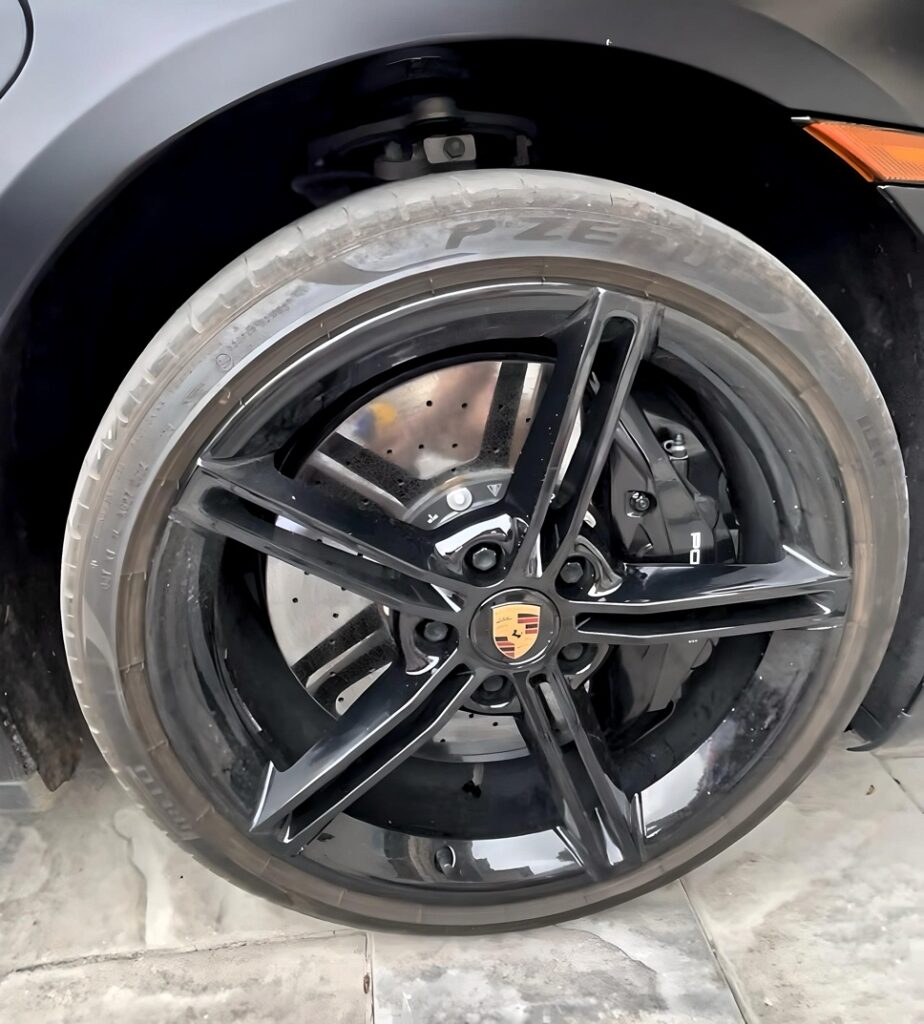 Dirty Porsche wheel full of brake dust and grime before being detailed